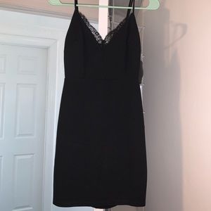 Black bodycon dress. Lace neckline detail